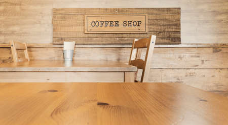 Vintage wooden interior coffee shop with selective focusing on wooden top table in morning light for montage product displayの写真素材