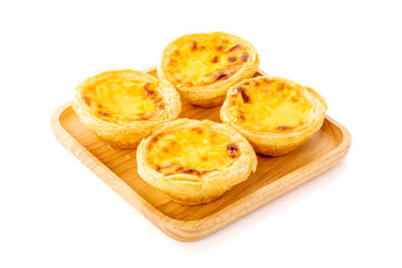 Egg tart the delicious crispy bekery on wooden plate isolated on white background