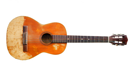 Old guitar on whiteの写真素材