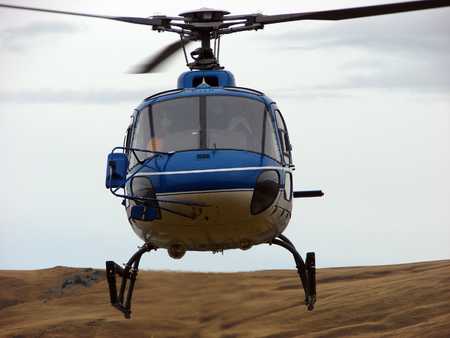 Blue helicopter on sky with cloudsの写真素材