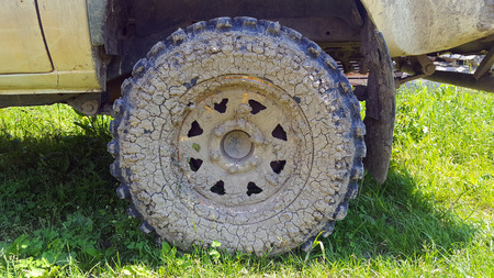 Vehicle car tire pick-up with mud on wheelの写真素材