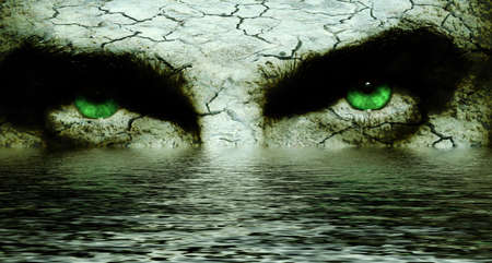 Mysterious cracked face with intense green eyesの写真素材