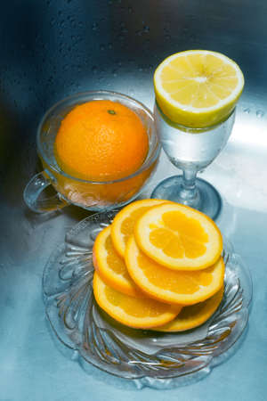 Cocktail of oranges and lemon, on icy blue backgroundの写真素材