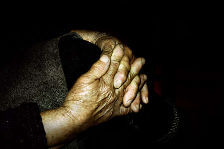Clopse up on wrinkled hands of an old womanの写真素材