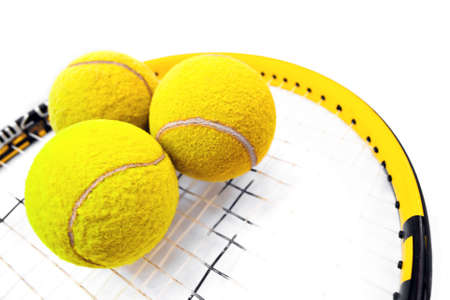 Close-up on three tennis balls standing on racquetの写真素材