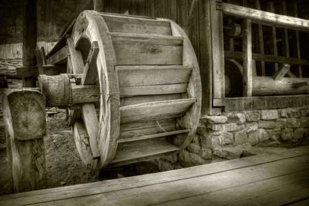 Antique waterwheel in a romanian villageの写真素材