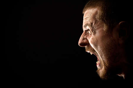 Angry man screaming in extreme rage