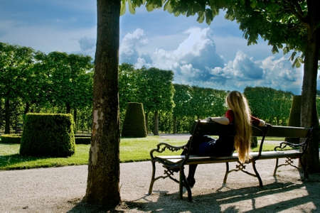 Back of young woman relaxing in parkの写真素材