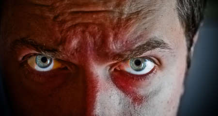 Close-up on criminal with blood on his face