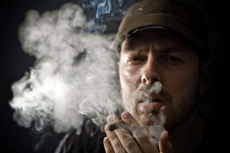 Portrait of cool looking guy smoking a cigarの写真素材