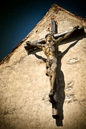 Wood sculpture of Jesus Christ on ancient wallの写真素材