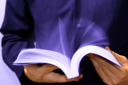 Fast learning concept: businessman reading a bookの写真素材