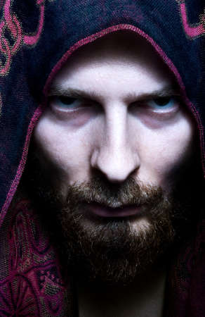 Portrait of mysterious scary man with evil look on his faceの写真素材