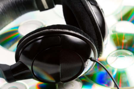 Modern music concept - headphones on top of audio cdsの写真素材