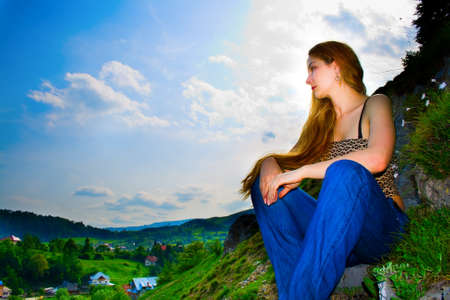 Woman high up looking over mountain panoramaの写真素材