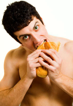 Unhealthy food - hungry man eating bread isolated on whiteの写真素材
