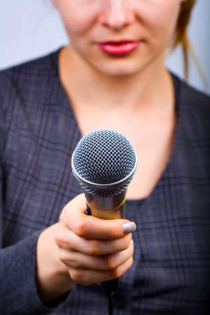 Reporter with microphone taking interview or opinion pollの写真素材