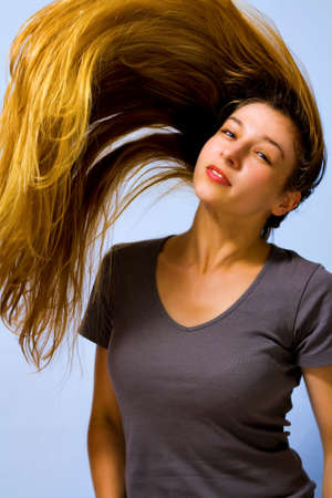 Active beautiful woman with long blond moving hairの写真素材