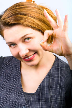 Portrait of beautiful woman showing ok signの写真素材