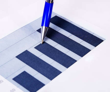 Business concept: pen and finance report over whiteの写真素材