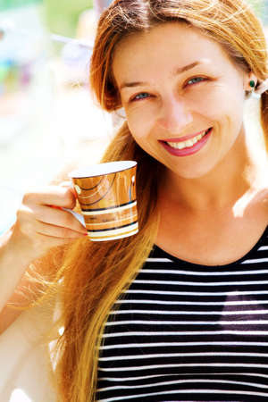 Portrait of beautiful smiling woman and coffee cupの写真素材