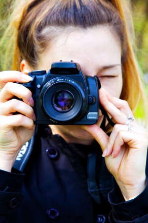 Female photographer with digital photo camera in handsの写真素材