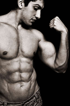 Portrait of sexy muscular man showing his bicepsの写真素材