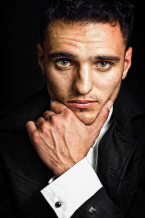 Pensive young man with expressive eyesの写真素材