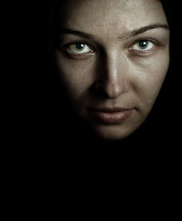 Face of spooky mystery woman in the darkの写真素材