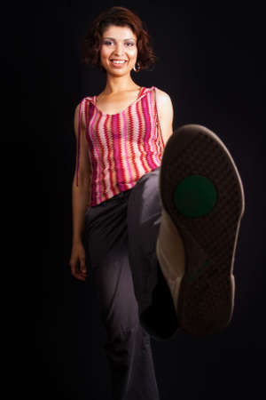 Woman kicking and showing her sport shoe sole