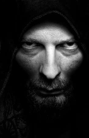Dark portrait of scary evil sinister bearded manの写真素材