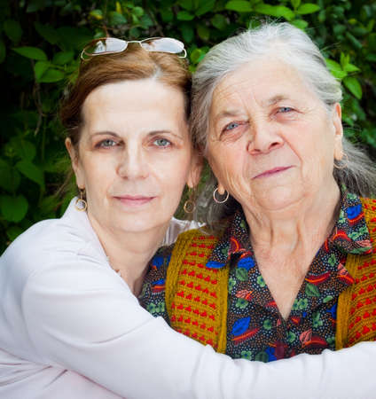 Family portrait - middle age daughter and senior motherの写真素材