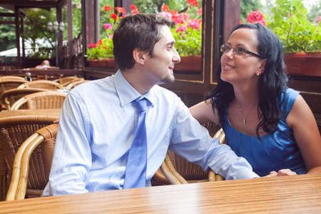 Cute joyful lovers at restaurant tableの写真素材