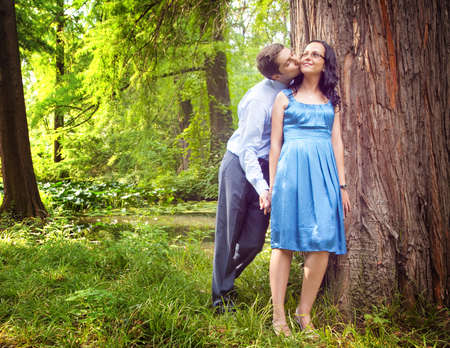 Couple having a candid romantic kiss outdoorsの写真素材