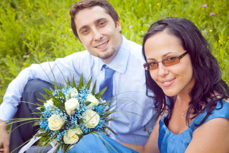 Portrait of cute beautiful couple in the grassの写真素材