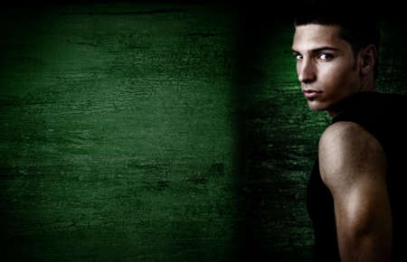 Masculine sexy young man and grunge wallの写真素材