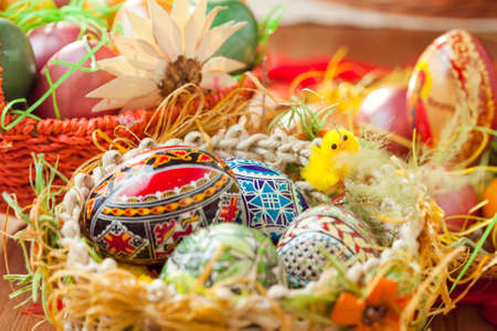 Easter painted eggs in traditional basketの写真素材