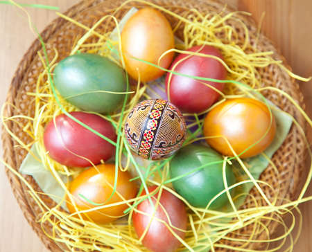 Colorful easter painted eggs in traditional basketの写真素材