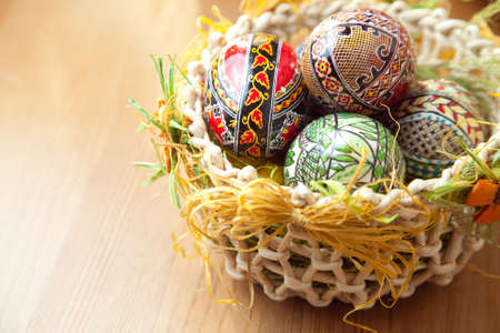 Easter painted colorful eggs in traditional basketの写真素材