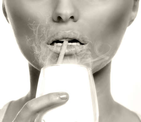 Passive or second hand smoking concept - woman inhaling smoke at the barの写真素材