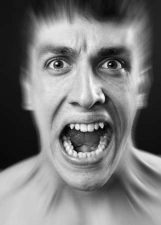 Loud scream of scared frighten young manの写真素材