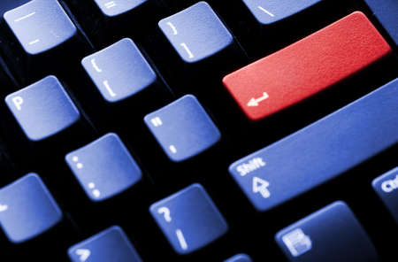 PC keyboard with blank enter key isolated on redの写真素材