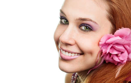 Happy woman with flower at ear isolated on white backgroundの写真素材