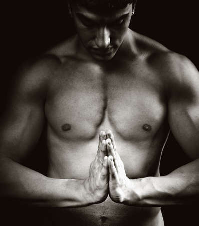 Spiritual concentration concept - muscular man doing yogaの写真素材