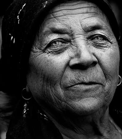 Dark artistic portrait of expressive senior ladyの写真素材