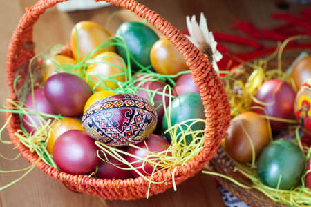 Colorful easter painted eggs in a basketの写真素材