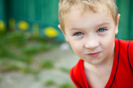 Portrait of cute expressive funny blond kidの写真素材