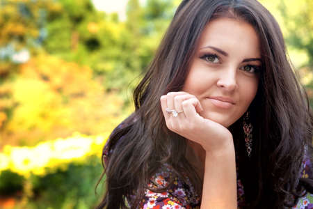 Portrait of one beautiful serene woman outdoorの写真素材
