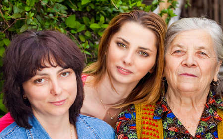 Family portrait - happy daughter granddaughter and grandmotherの写真素材