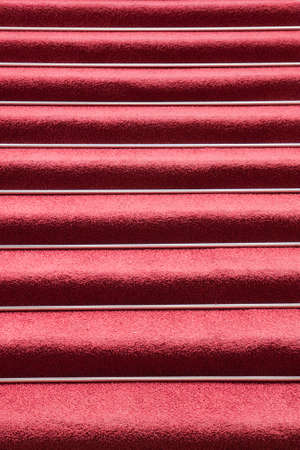 Abstract image of red carpet on symmetrical stairsの写真素材